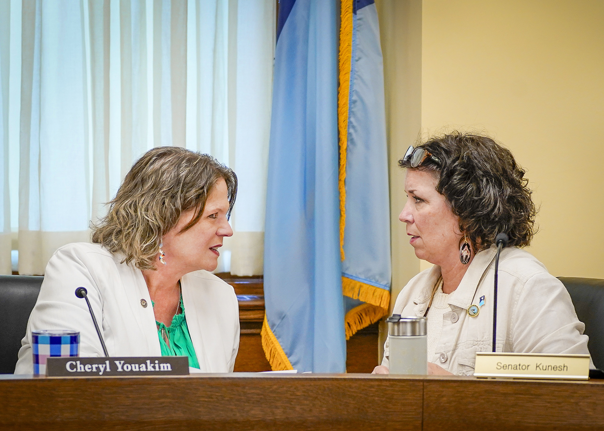 Rep. Cheryl Youakim and Sen. Mary Kunesh confer during the May 15 meeting of the education supplemental budget bill conference committee. (Photo by Andrew VonBank)